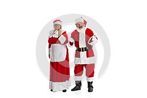 Portrait of two people, man in Santa Claus costume and crying woman, missis Claus isolated on white background.