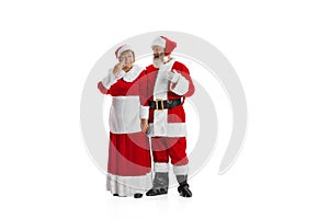 Portrait of two people, man in Santa Claus costume and crying woman, missis Claus isolated on white background.