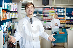 Portrait of two pharmacists working in modern farmacy photo