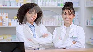 Portrait of two proud and confident pharmacists with arms crossed in a pharmacy dispensing over the counter prescription