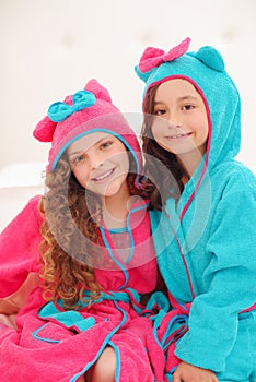 Portrait of two sister wearing a bathtowel with hood