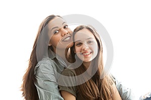 Portrait of two sisters next to a big bright window