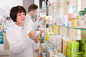 Portrait of two smiling adult pharmacists