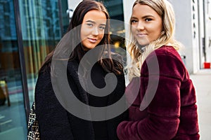 Portrait Of Two Smiling Beautiful Young Women Friends In City