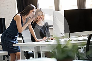 Portrait of two smiling business woman working in office