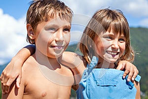 Portrait of two smiling children on nature