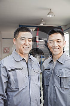 Portrait of Two Smiling Garage Mechanics