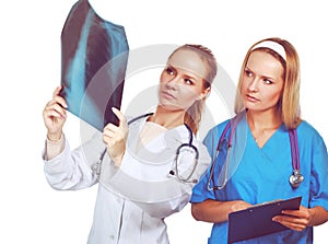 Portrait of two successful female doctors holding a writing pad and x-ray