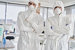 Portrait of two technicians in protective workwear ready to work