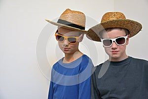 Confident teenage boys  with straw hats photo