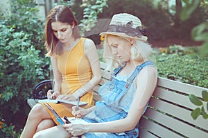 Portrait of two white Caucasian unformal young girls hipster students teenagers friends