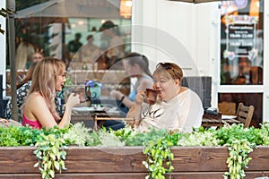 Portrait of two women, a mother and her daughter sitting in a cafe