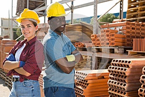 Portrait of two workers posing at a construction store