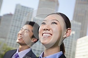 Portrait of two young business people outside in the business district, Beijing