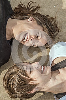 Portrait of two young girls smiling on the beach