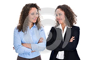 Portrait of two young isolated business woman - real twins.
