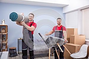 Portrait Of Two Young Male Movers Loading The Products