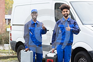 Portrait Of Two Young Manual Worker With Their Tool Boxes