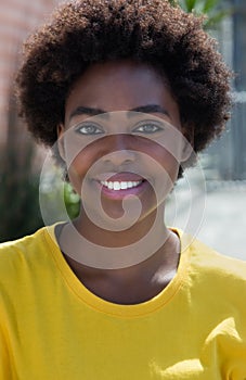 Portrait of a typical african american woman in a yellow shirt