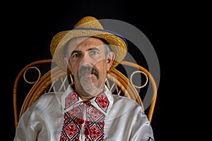 Portrait of Ukrainian country-man sitting in a wicker chair