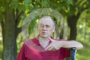portrait of Ukrainian mature man standing in a park