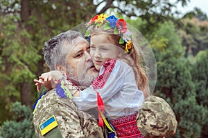 Portrait of a Ukrainian soldier with his little daughter