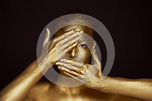 Portrait unearthly Golden girls, hands near the face. Very delicate and feminine. The eyes are open. Frame of hands