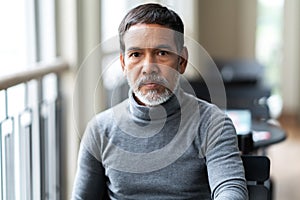 Portrait of unhappy angry mature asian man with stylish short beard looking at cemera with negative suspicious