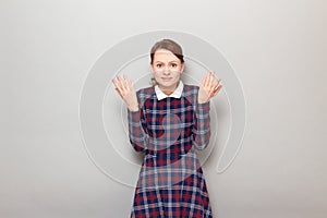 Portrait of unhappy bewildered woman raising and waving her hands