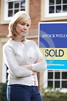 Portrait Of Unhappy Mature Woman Forced To Sell Home Through Financial Problems