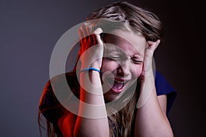 Portrait of unhappy screaming teen girl