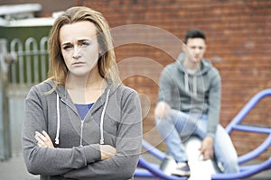 Portrait Of Unhappy Teenage Couple In Urban Setting