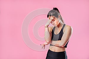 Portrait of unhappy upset woman frowns her face, about to cry, being unhappy as she cannot achieve goals, isolated on pink studio
