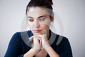 Portrait of unhappy woman on gray background