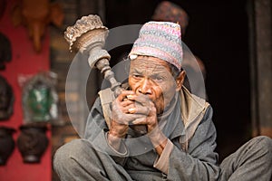 Portrait of unidentified Nepalese man smokes on the street