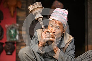 Portrait of unidentified Nepalese man smokes on the street.