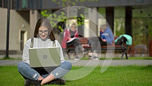 Portrait of university college teenager student studying working using laptop computer