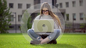 Portrait of university female student studying, using laptop computer