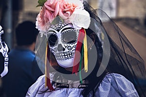 Portrait of unknown woman wearing Dia de Los Muertos sugar skull mask, dark edit