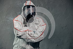 Portrait of unrecognizable disinfector in gas-mask