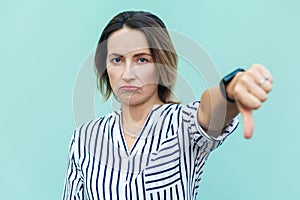 Portrait of unsatisfied sensual lady with thumbs down and white