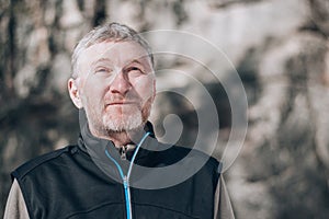 Portrait of an unshaven attractive and happy middle-aged man outdoors. People and lifestyle concept. Copy space