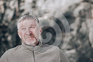 Portrait of an unshaven attractive and happy middle-aged man outdoors. People and lifestyle concept. Copy space