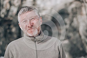 Portrait of an unshaven attractive and happy middle-aged man outdoors. People and lifestyle concept. Copy space