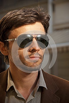 Portrait of an unshaven man model with sunglasses