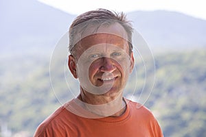 Portrait of an unshaven middle-aged man relaxing on the nature in summer day