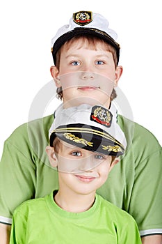 Portrait up of two boys in sea peak-cap