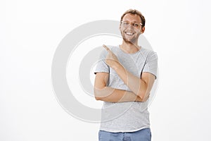 Portrait of upbeat carefree handsome european man with bristle in glasses smiling and laughing casually having great day