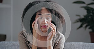 Portrait of upset Afro girl feels grief, sadness, misunderstanding quarrel, broken heart, sits indoor thoughtfully