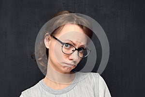 Portrait of upset girl with eyeglasses pouting lips